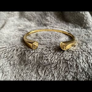 MK gold toned bangle.